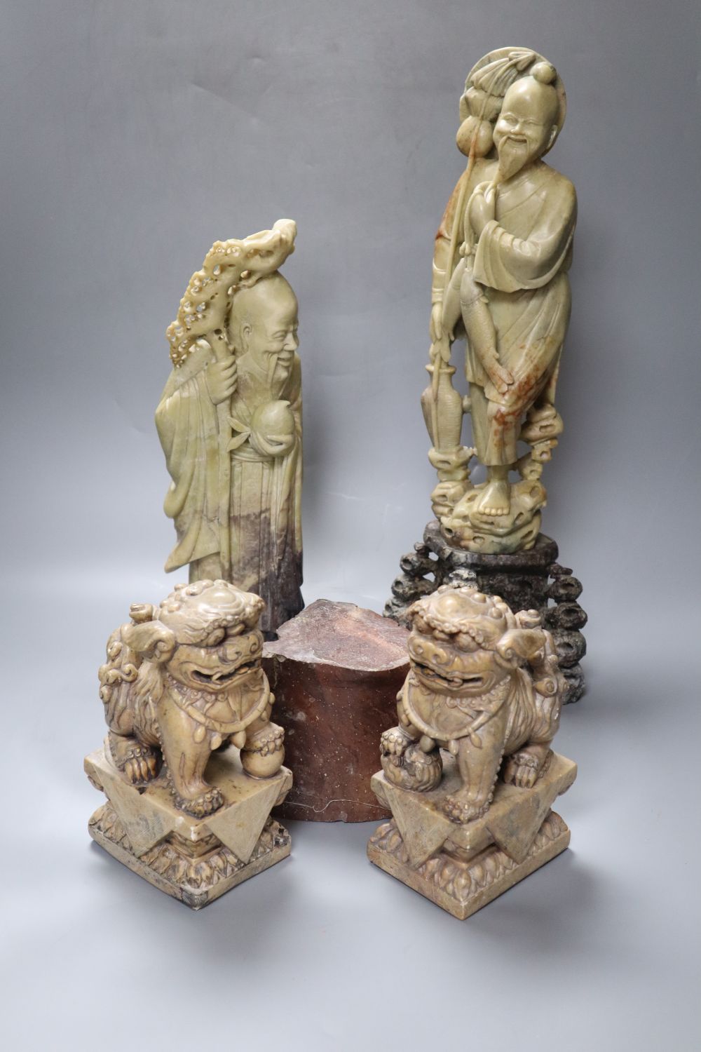 A pair of large Chinese soapstone figures of immortals, tallest 43cm and a pair of similar Buddhist lions